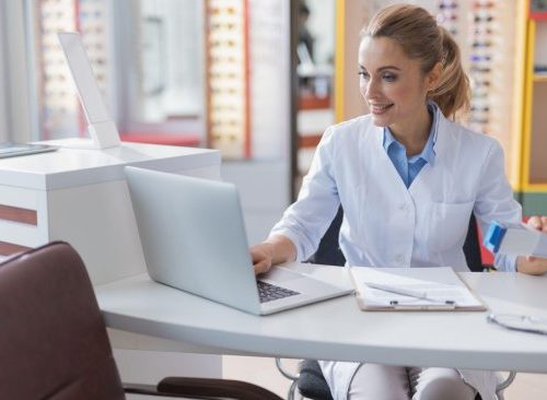 optometrist working at a desk