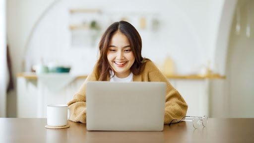 smiling woman using her laptop