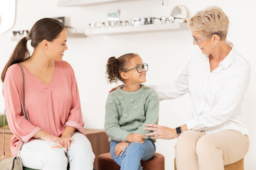 parent and child speaking with an optometrist
