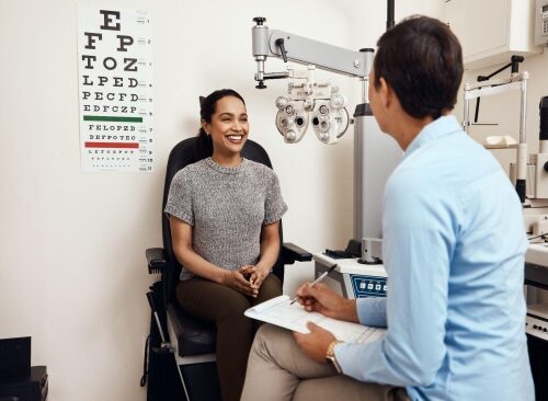 optometrist showing patient centered care by listening intently